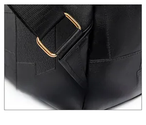 Detail of reinforced triangle stitching and gold metal buckle on black PU leather backpack
