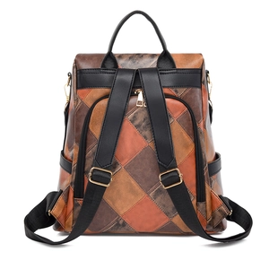 Detail of colorful patchwork leather backpack with gold zippers and back anti-theft pocket