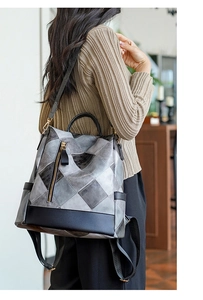 Modern anti-theft backpack with black and grey patchwork and polished metal zippers
