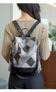 Close-up of diamond pattern PU leather anti-theft backpack with metallic zippers