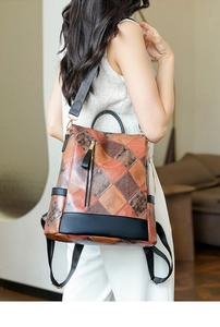 Detail of anti-theft back pocket and retro patchwork leather texture on fashion backpack