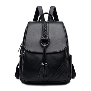 Black leather backpack with fringe pendant and woven detail for women's travel