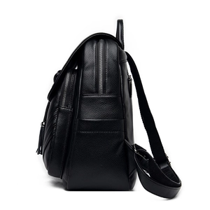 Side view of black lychee leather backpack showing multi-layer zippers and tassel charm