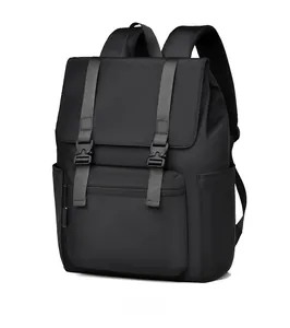 Detail view of matte black waterproof backpack with flap cover and dual buckle straps