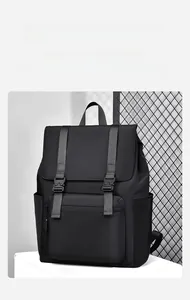 Detail of black waterproof laptop backpack with double buckle flap and front pocket