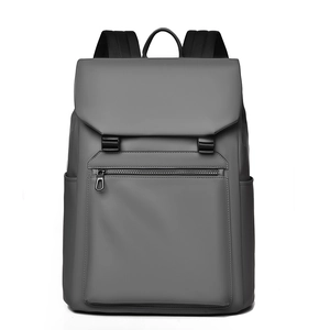 Front view of dark grey business backpack showing waterproof fabric and flap closure