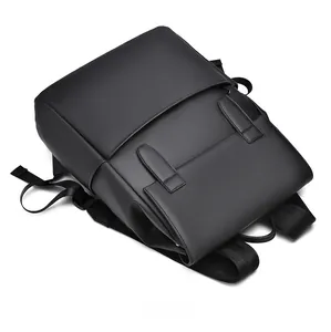 Top view of black minimalist business backpack featuring a flap cover and dual buckle straps
