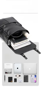 Vue à plat du sac à dos en cuir noir montrant les compartiments internes et le rangement