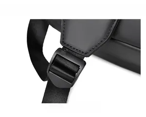 Detail of durable nylon shoulder strap with matte adjustable buckle on a black backpack