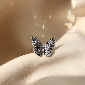 Detailed close-up of 925 sterling silver butterfly ring with vintage embossed textures
