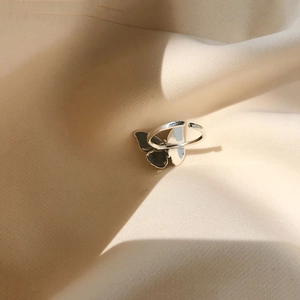 Detail view of 925 sterling silver butterfly open ring with black and white wings