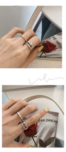 Detail of star and moon multi-layer silver rings set styled with a vintage magazine
