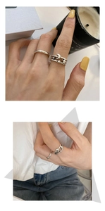 Detail of silver star and moon rings set with multi-layer design on finger