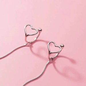 S925 silver hollow heart drop earrings with box chain on elegant pink background