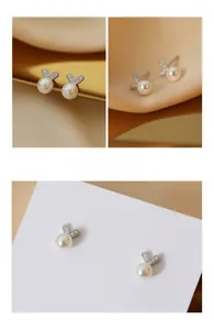 Détails macro de boucles d'oreilles cœur en argent S925 avec perles et zircons brillants