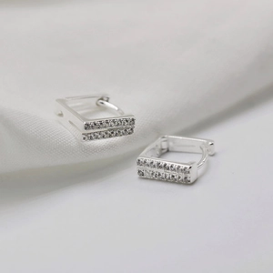 Macro shot of S925 sterling silver rectangular earrings with double-row zircon pavé