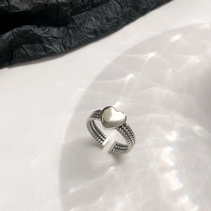 Vintage S925 sterling silver heart open ring with woven band on artistic water shadow background