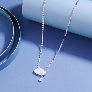 Detail of silver cloud pendant necklace with mother of pearl and teardrop zircon drop
