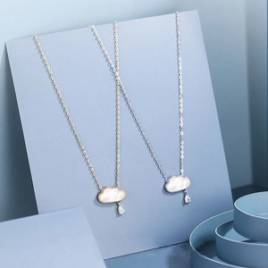 Minimalist cloud pendant necklace with teardrop zircon drop on blue elegant background