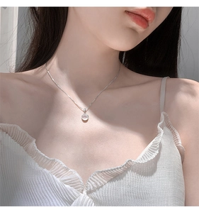 Detailed close-up of a 925 sterling silver necklace with a round white chalcedony pendant