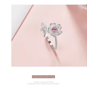 Detail of adjustable cherry blossom ring with pink zircon stone in silver finish