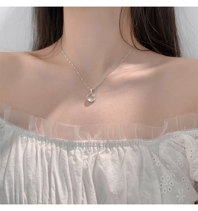 Elegant 925 sterling silver necklace with round chalcedony pendant on a female model