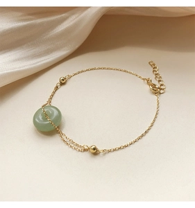 Detail view of jade stone pendant and adjustable gold plated sterling silver chain