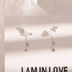 Close-up of 925 silver flower tassel earrings with cherry blossom and delicate crystals