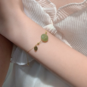 Elegant 18K gold-plated silver bracelet with green jade bead and Disney logo tag