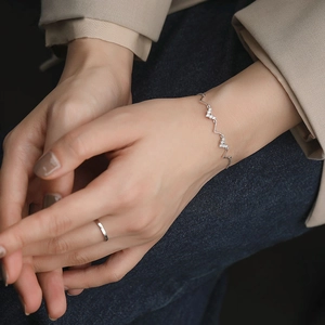 Bracelet minimaliste en argent S925 en forme d'onde avec pierres sur poignet femme