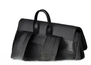 Close-up of matte waterproof fabric and durable reinforced handle on black backpack