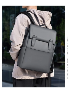 Outdoor shot of a minimalist dark gray business laptop backpack with waterproof PU texture