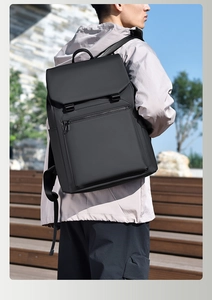 Waterproof matte black backpack detail showing top flap closure with dual adjustable buckles