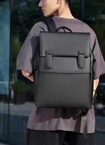 Close-up of black structured commuter backpack with matte finish and dual vertical straps