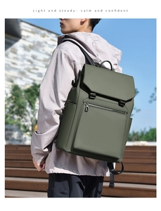 Detailed side view of a dark green waterproof backpack with buckle closure outdoors