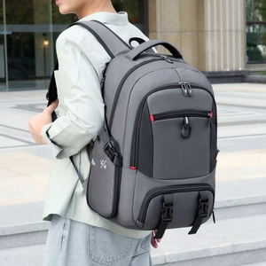 Detail of grey travel backpack side showing buckles and waterproof function icons