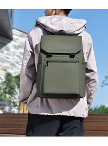 Outdoor shot of olive green waterproof travel backpack showing large capacity and flip cover