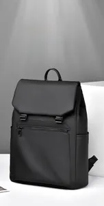 Detailed close-up of a waterproof black business backpack with buckle closure and side pocket