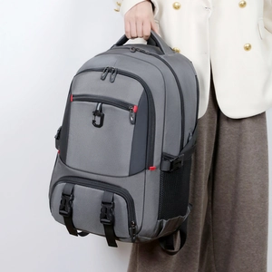 Detail of grey hiking backpack featuring reinforced top handle and multiple zip compartments