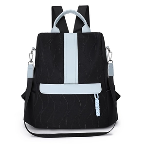 Women's black quilted backpack with light blue contrast panels and detachable straps