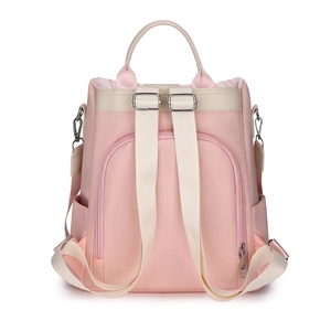 Rear view of a pink nylon backpack with beige straps and a secure anti-theft zipper pocket