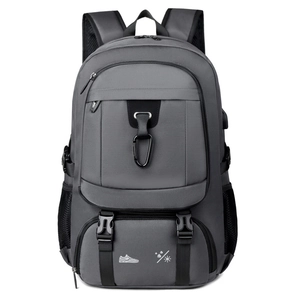 Large dark grey travel backpack with USB charging port and separate shoe compartment
