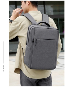 Side view of dark grey business backpack showing texture and padded shoulder straps
