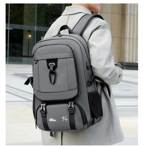 Detail view of grey travel backpack showing waterproof fabric and shoe compartment icon
