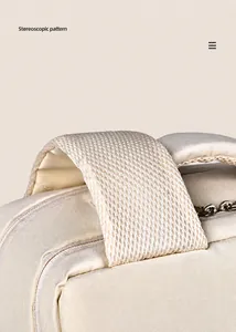 Detail of padded breathable mesh shoulder straps and metallic zipper on beige backpack