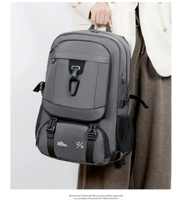 Detail of grey travel backpack showing water-resistant fabric and shoe compartment icon