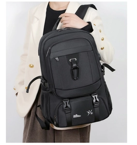 Detail of a large black tactical backpack showing its durable nylon fabric and secure buckles