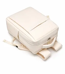 Top view detail of off-white minimalist laptop backpack showing handles and zippers