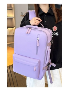 Detail view of large lavender travel backpack featuring multi-pocket design and side buckles
