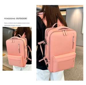 Pink waterproof travel backpack featuring multi-layer compartments and USB charging port